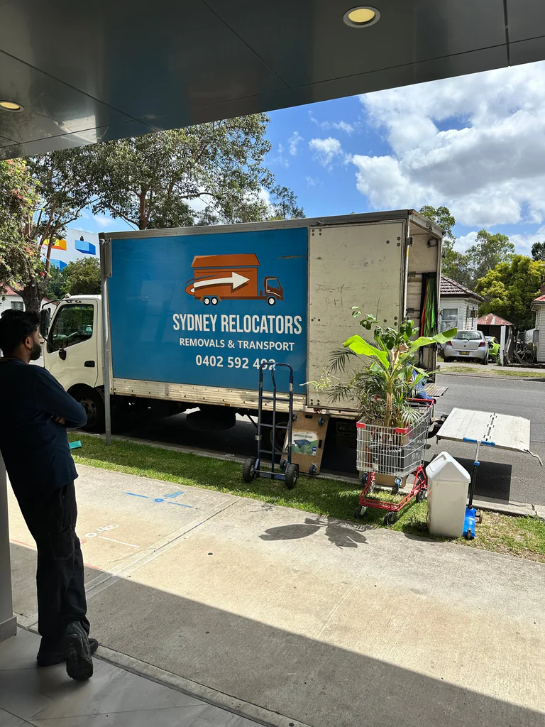 Cartons and household items trolleyed out to the truck from a driveway